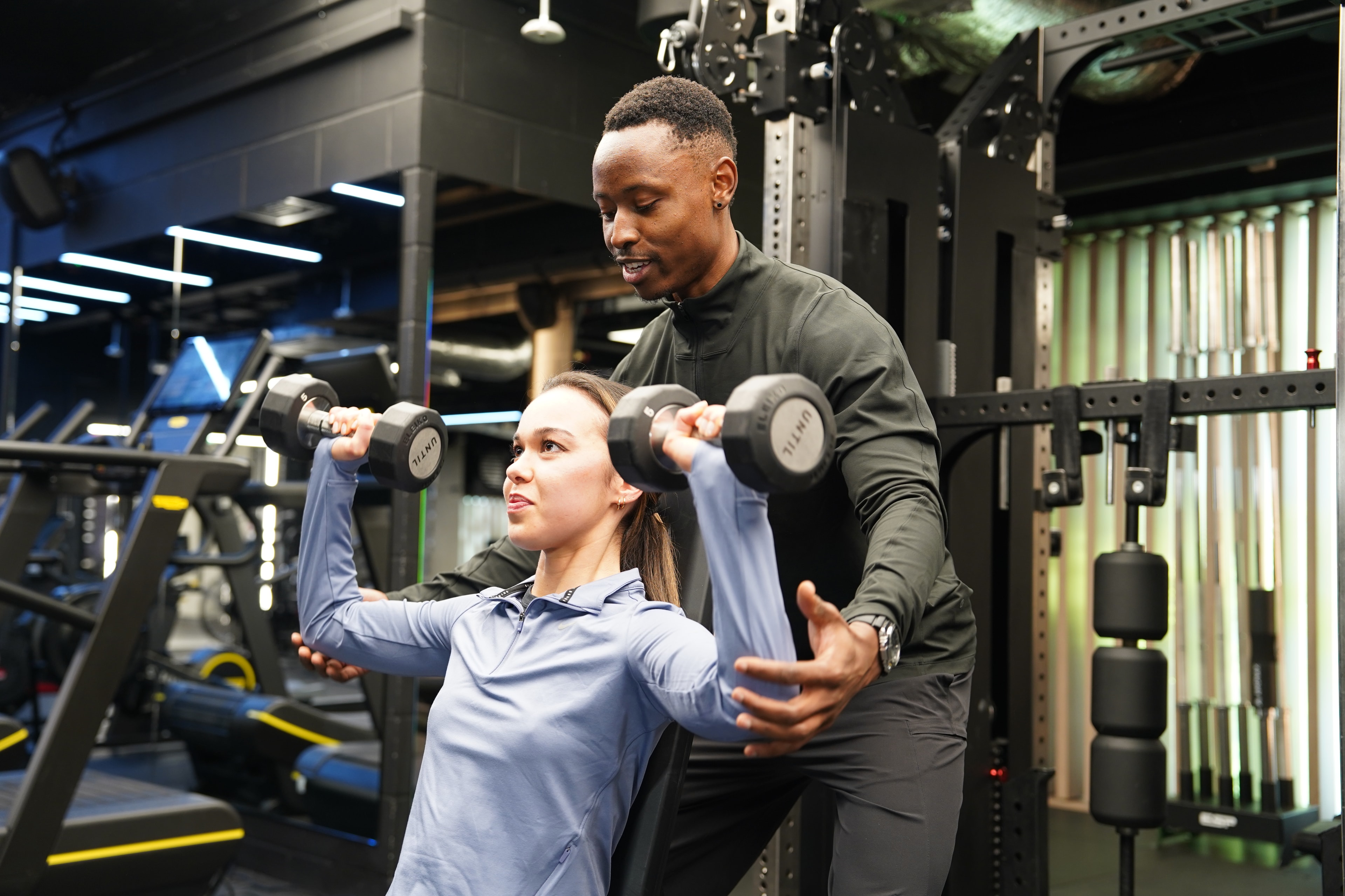 Brendon Kawondera coaching client through training technique in private gym
